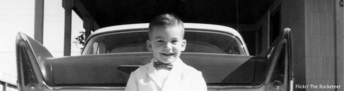 Child standing in front of a car