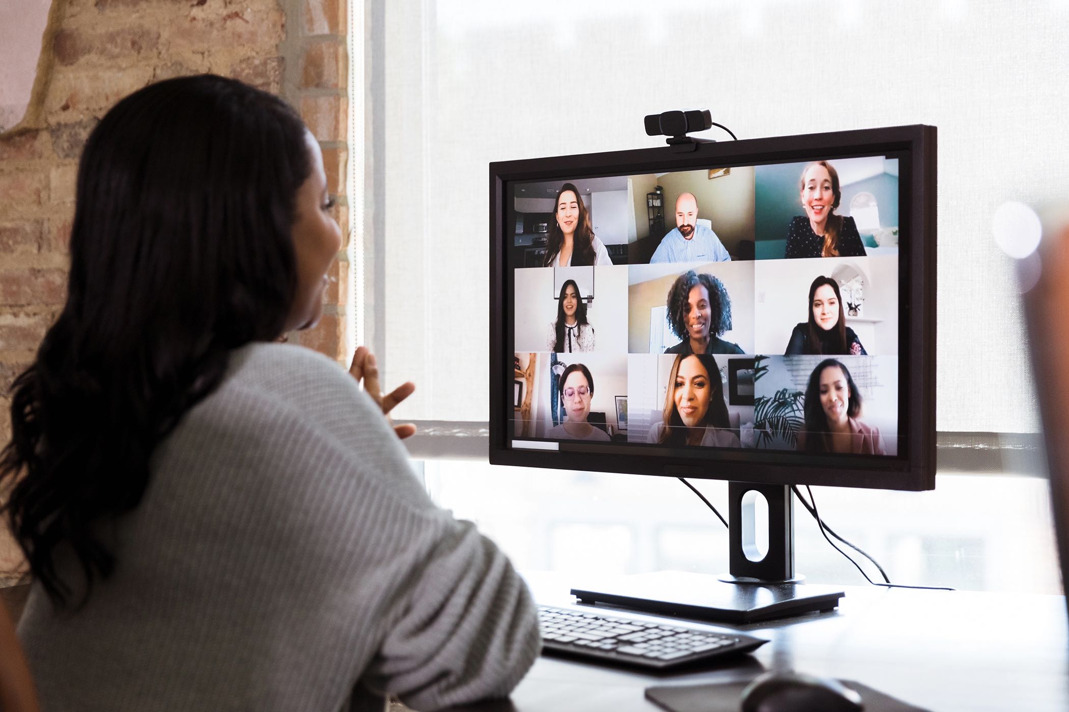 woman at desk talking on Zoom call