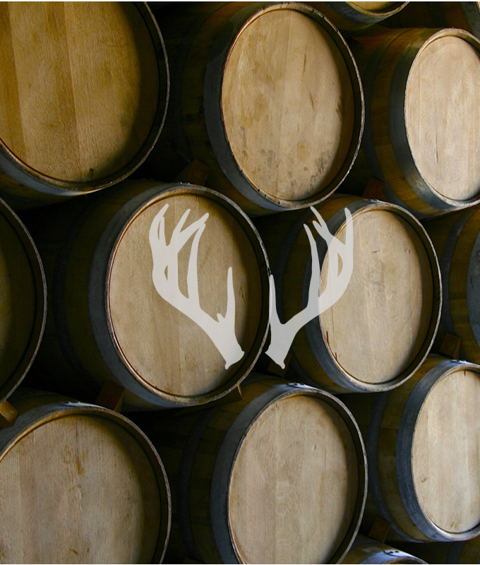A stack of wooden barrels with a white antler graphic overlay on the right side reflects Meadow Lands' passion for craftsmanship; the left side is a gray panel labeled "Section 12 Image Left 683 x 800.