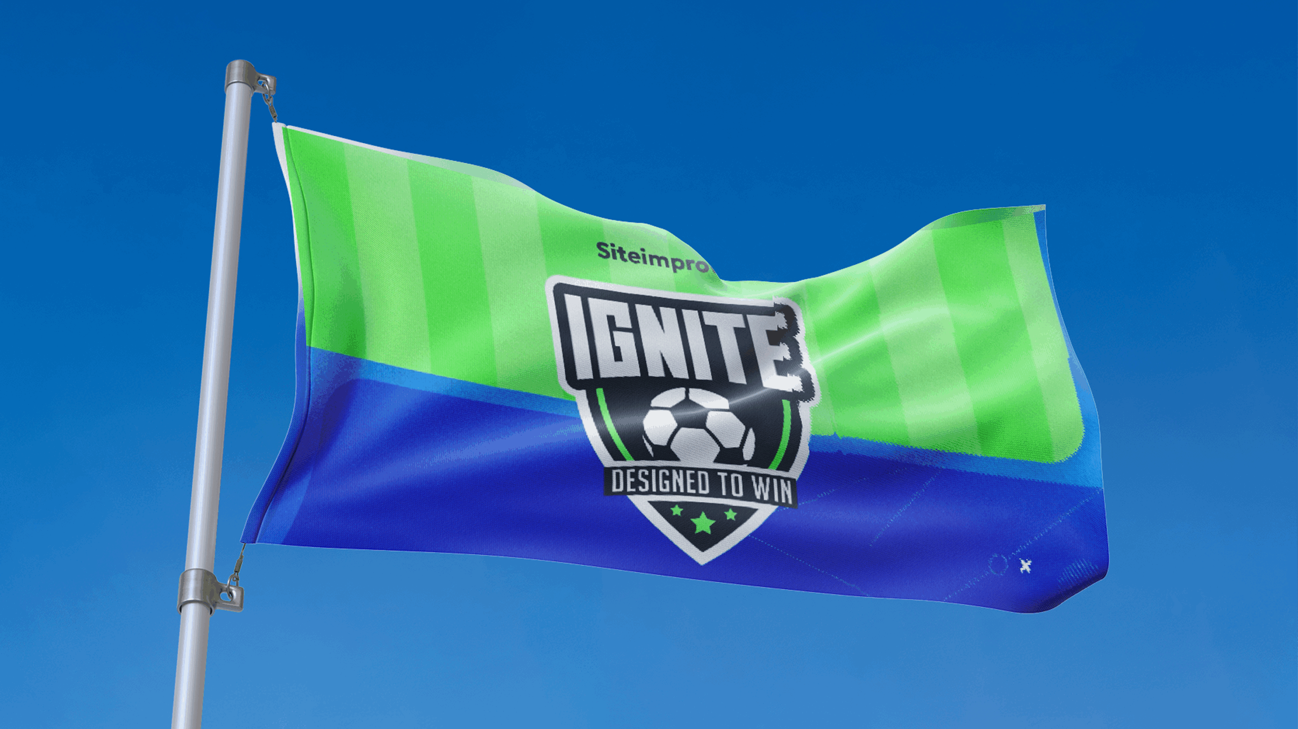 A flag with green and blue horizontal stripes displays a soccer-themed shield logo reading "IGNITE Designed to Win," celebrating team spirit against a clear blue sky.
