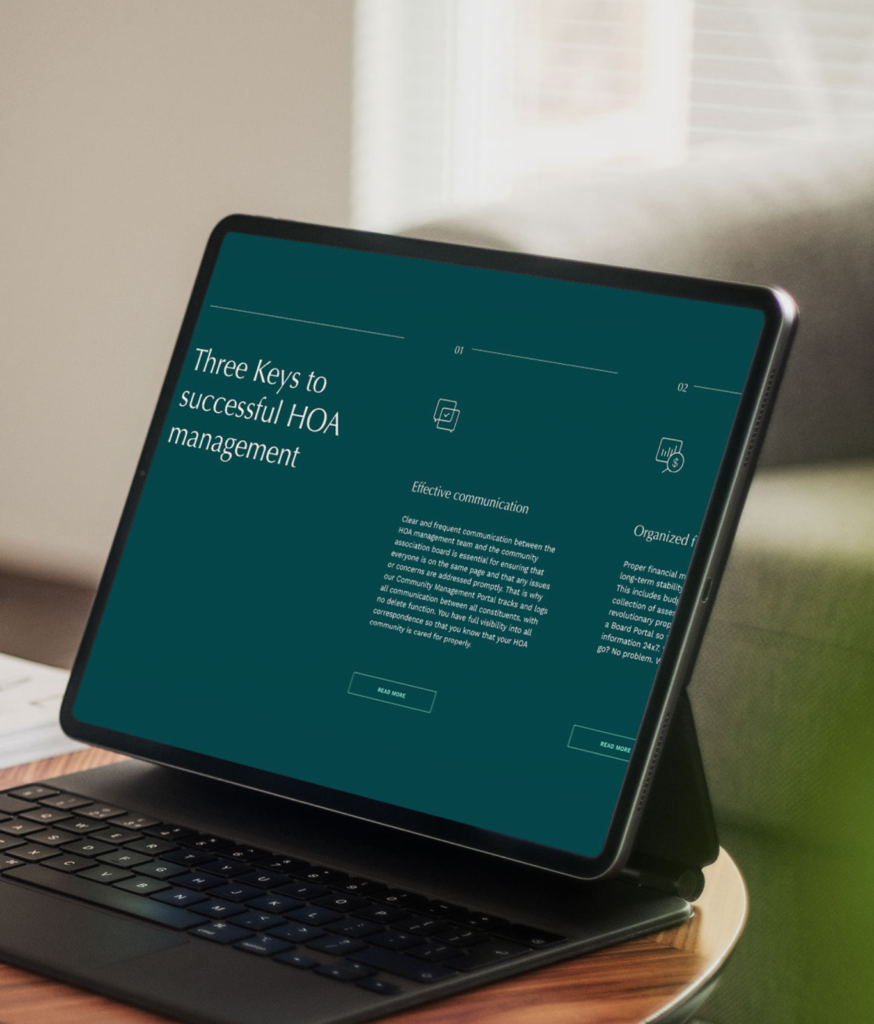 A tablet on a keyboard stand displays a presentation titled "Three Keys to Successful HOA Management," highlighting property management strategies with text and icons, positioned on a wooden table near a green chair.