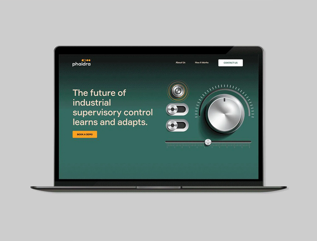 A laptop displays a website with the text "The future of industrial supervisory control learns and adapts" and control knobs on a green background.