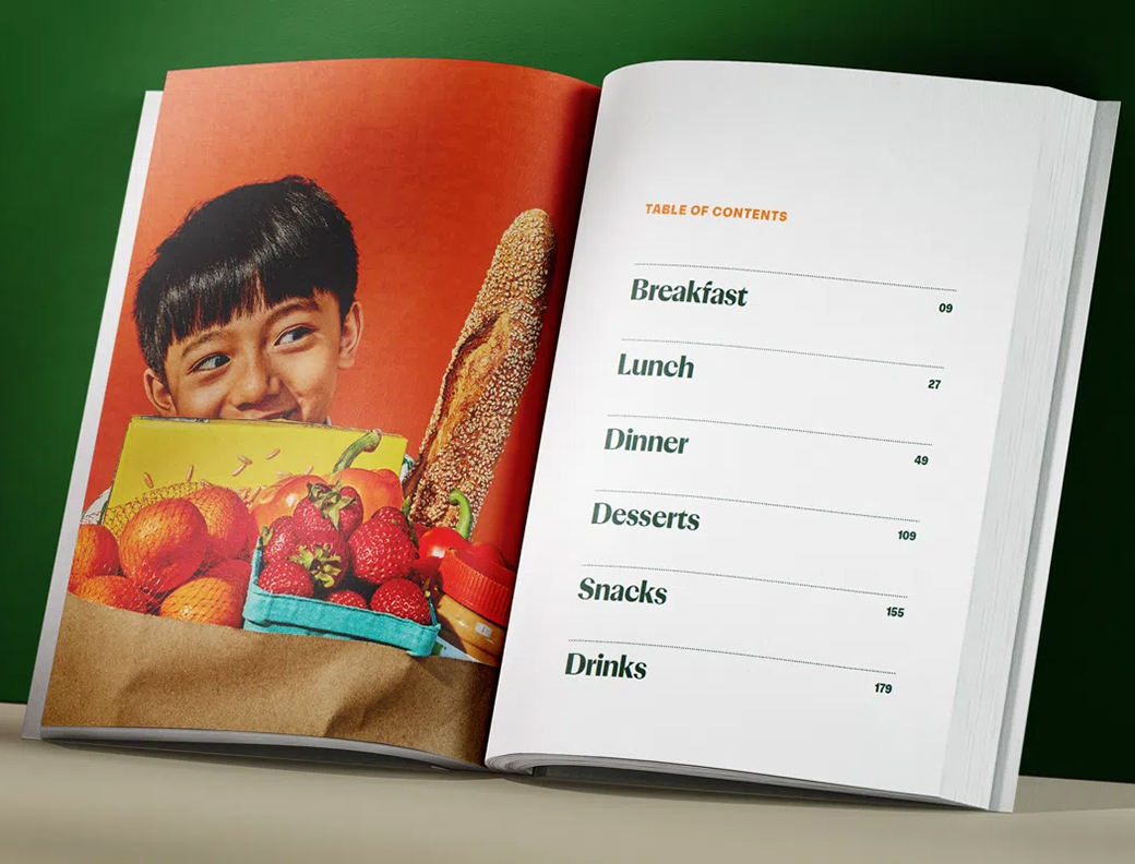 An open book displays a smiling child holding a bag of groceries on the left page and a table of contents with meal categories on the right page.