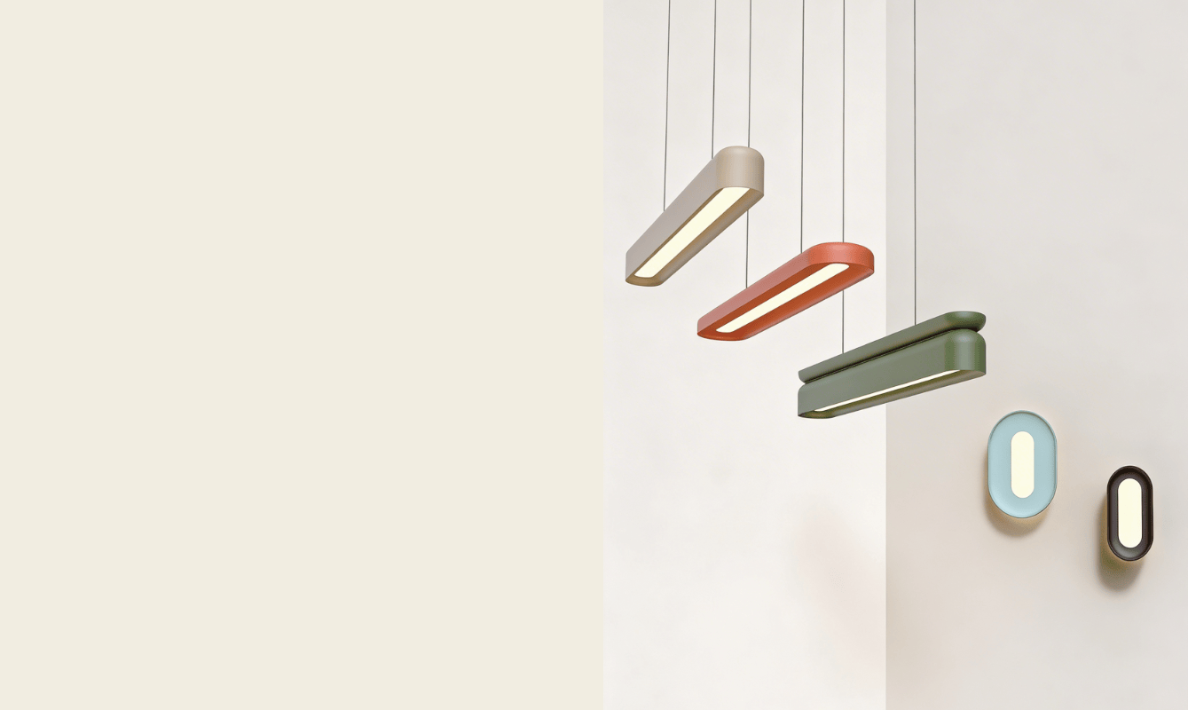 Four modern Nulite pendant lights in neutral, orange, and green hang from the ceiling; below, two oval wall lights—one blue and one brown—enhance the space with a premium brand identity on a white wall.
