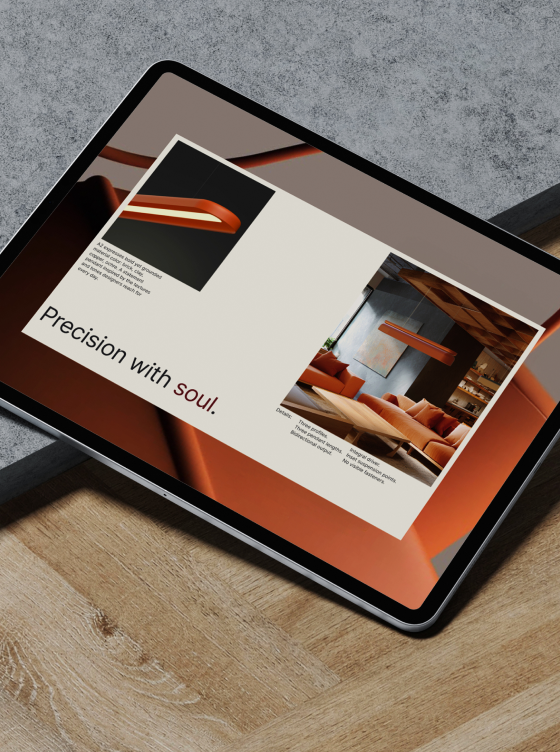 A tablet displays a product presentation with images of a modern orange light fixture and a furnished room, alongside the text "Precision with soul," reflecting Nulite's commitment to premium brand identity.