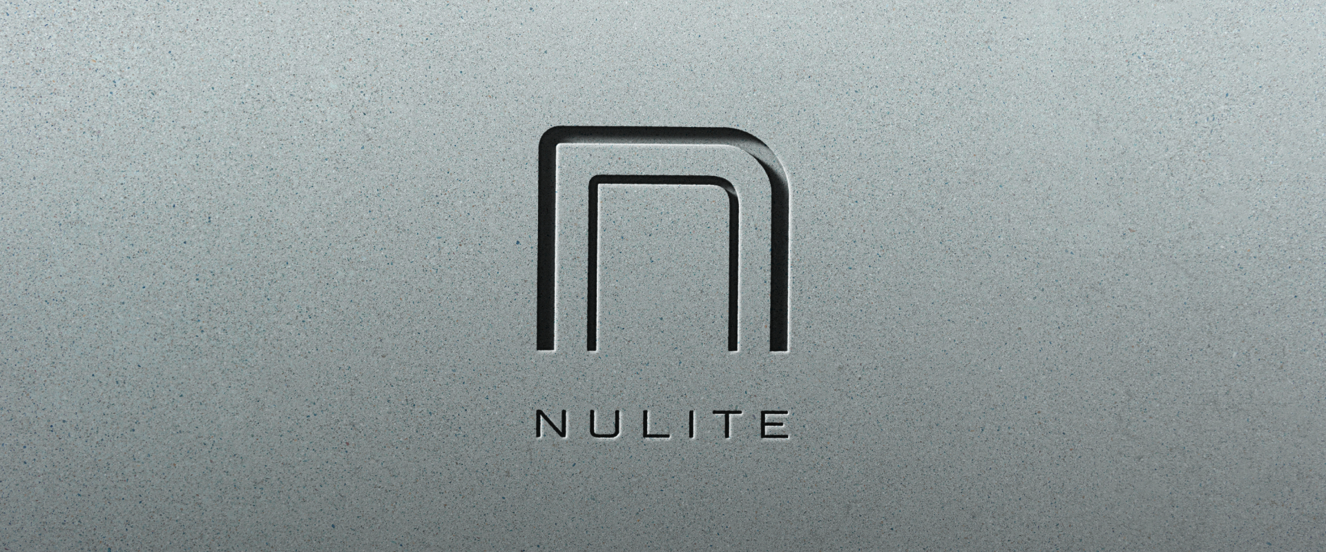 Minimalist logo featuring a stylized, rounded letter "N" above the word "NULITE," embossed on a gray, textured surface, reflecting core brand values and inspiring brand growth.