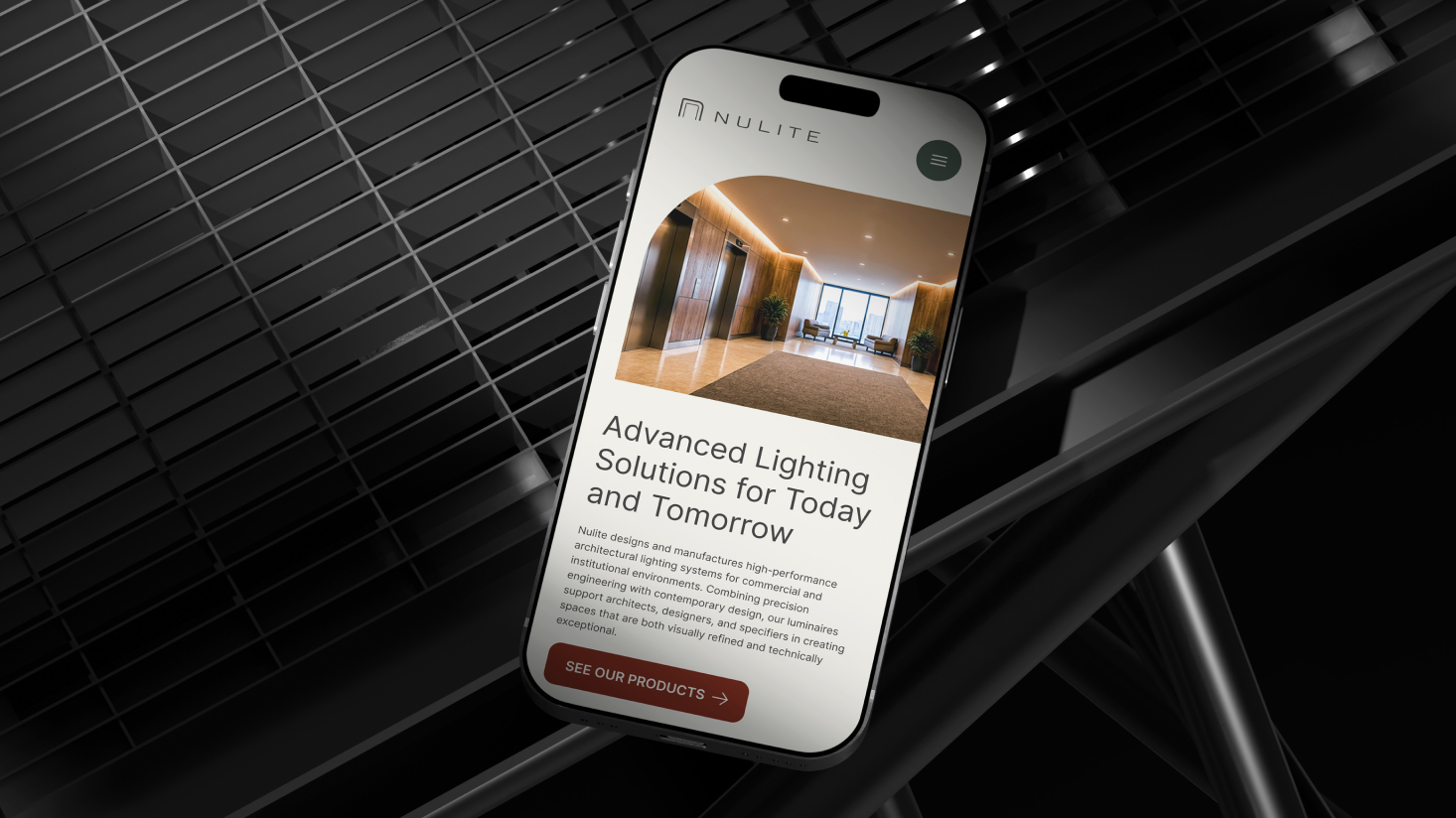 A smartphone displays the Nulite website, showcasing a modern lobby and the headline "Advanced Lighting Solutions for Today and Tomorrow," reflecting growth at the core of the Nulite brand.