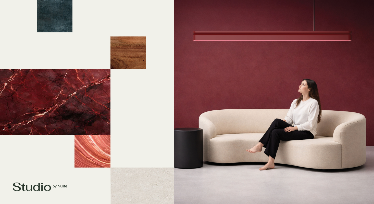 A woman sits barefoot on a curved white sofa against a dark red wall, with decorative material samples displayed on the left, embodying premium brand identity. "Studio by Nulite" text appears in the corner.