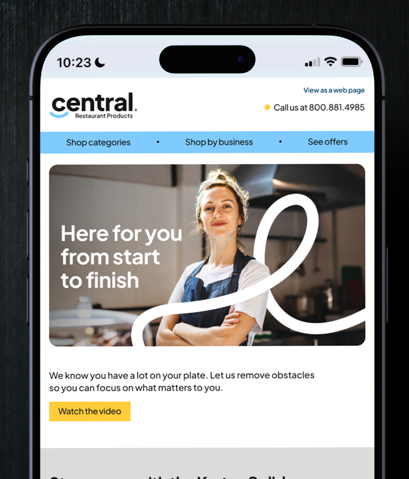 A smartphone screen displays the Central Restaurant Products website, featuring a woman in an apron and chef’s hat with arms crossed in a commercial kitchen—highlighting leading brands from TAKKT Foodservices.
